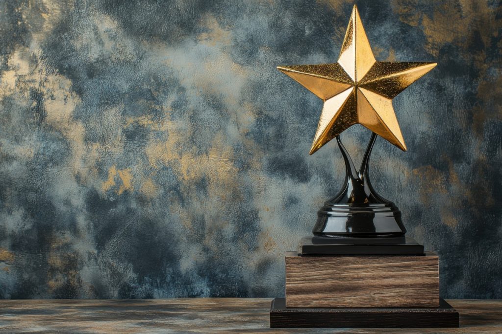 A gold star trophy on a black and wood-textured base, set against a mottled blue and gold background.